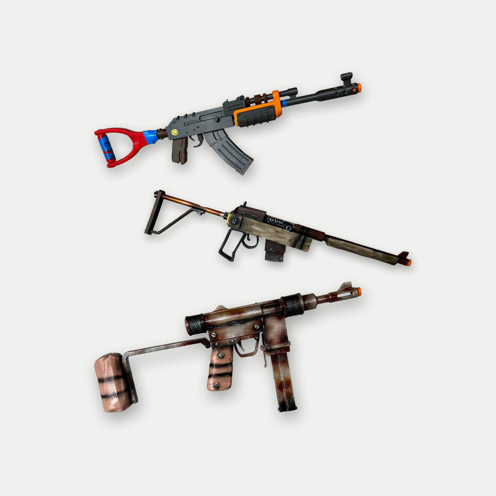 Rust Mini kit, the Mini AK, Mini SAR and Mini SMG stacked at equal size, three desk-size hand-painted props on a light studio ground