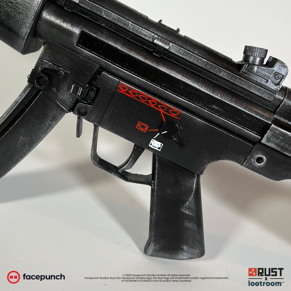 Close-up of the Rust MP5 prop receiver with the painted red fire-selector markings