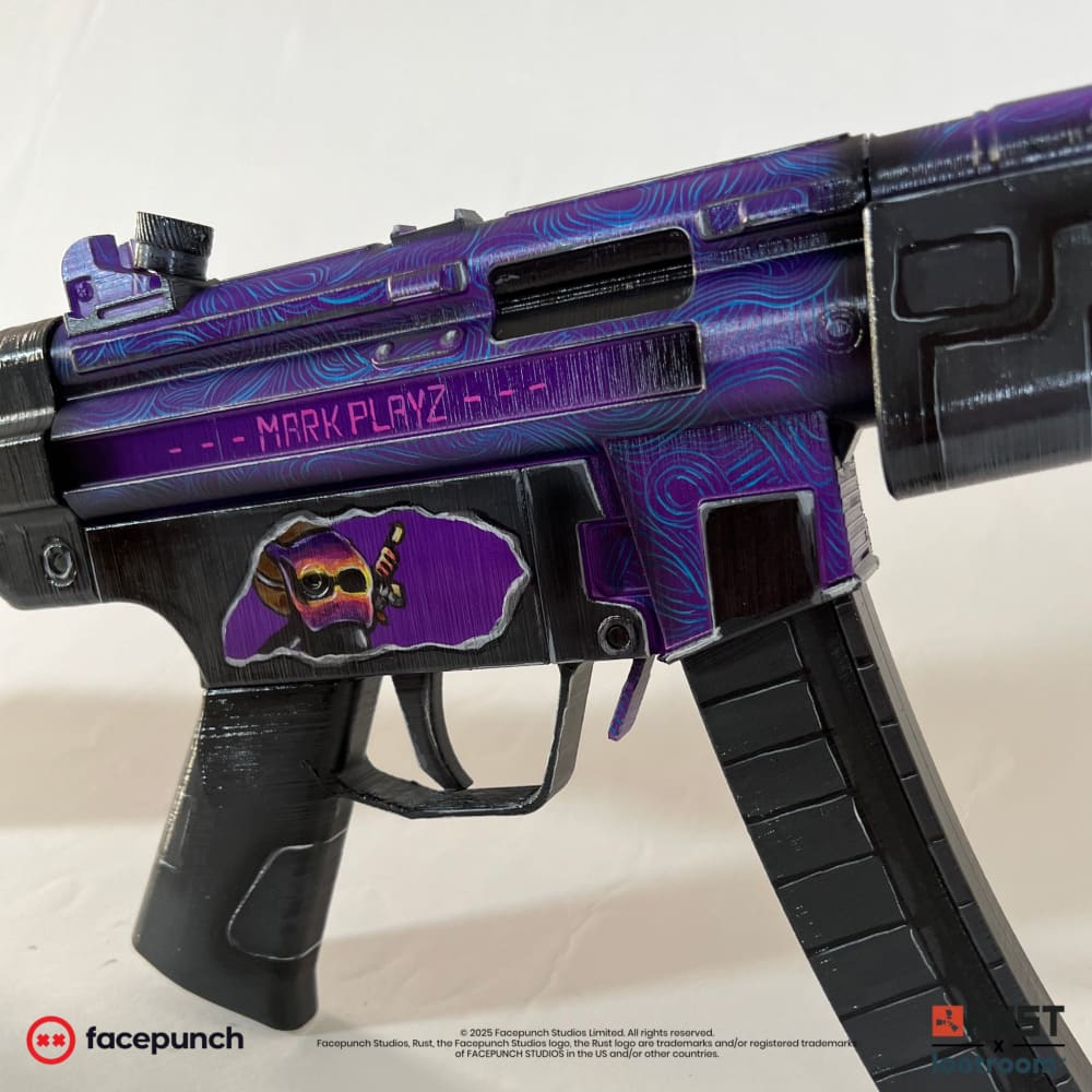 Close-up of the Rust MarkPlayz MP5 prop's receiver with the MARK PLAYZ lettering and the avatar in its pale panel.