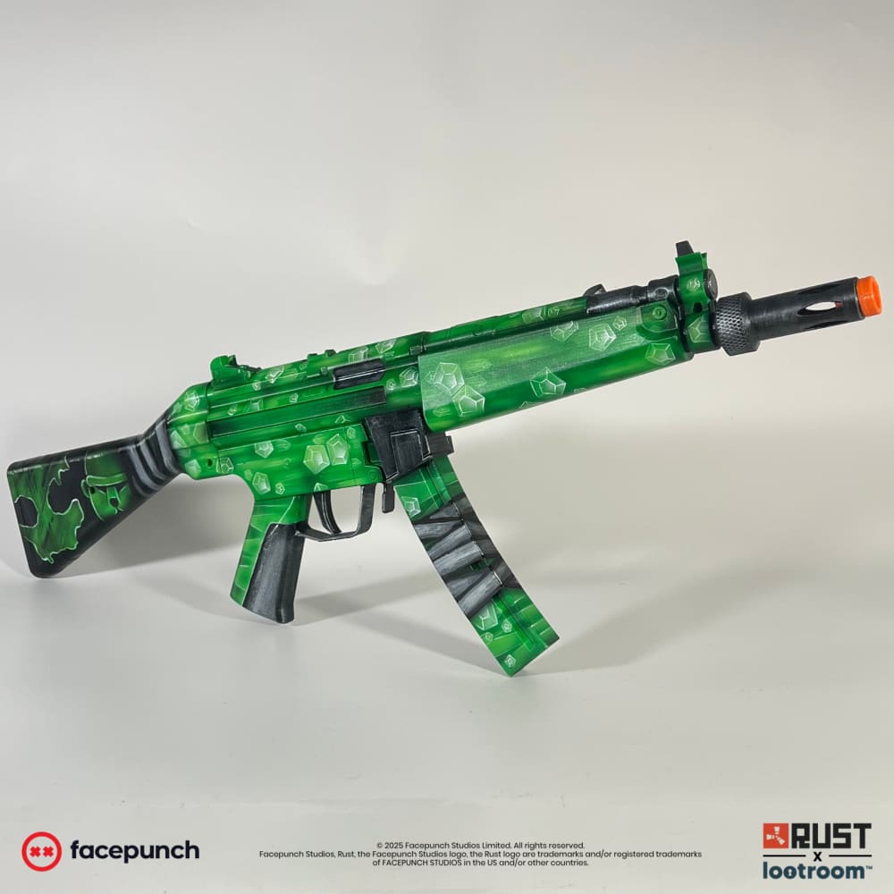 Rust Oilrats MP5 replica from the front right, green facets along the barrel shroud and the black trigger group