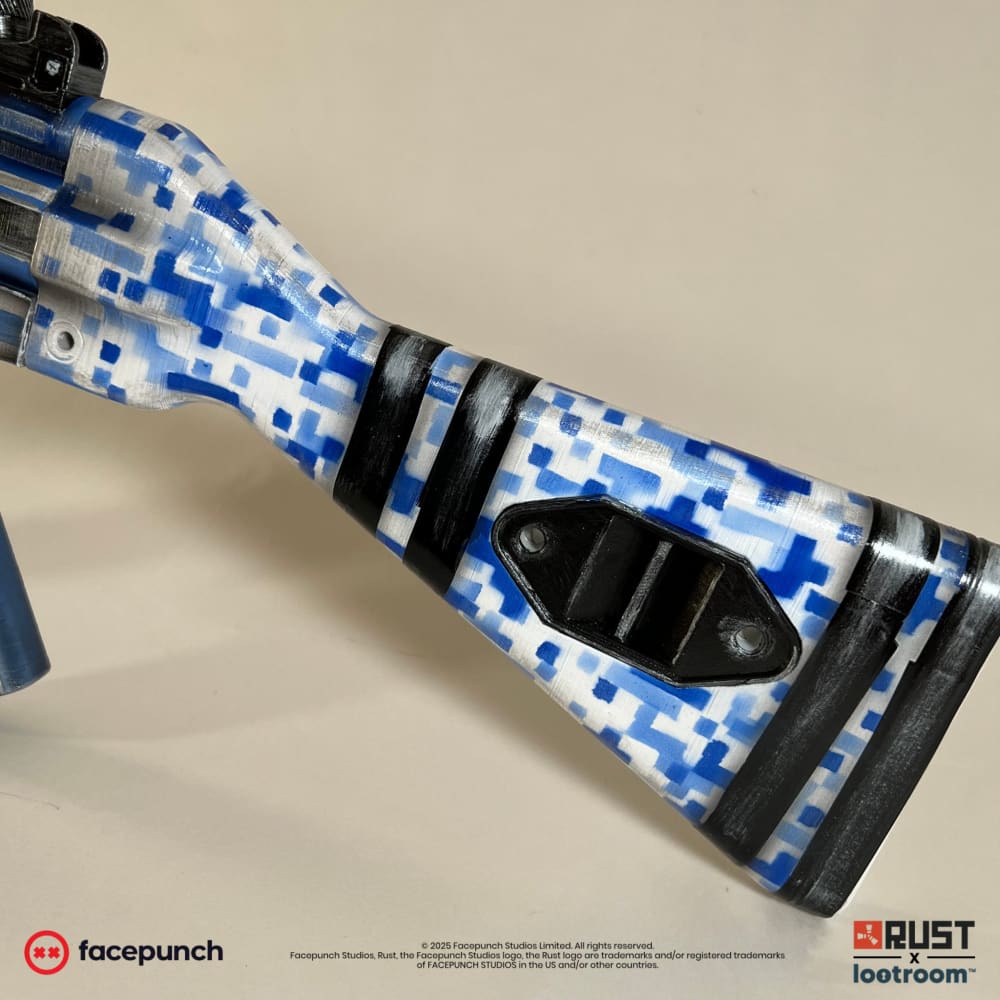 The stock of the Rust Sinks MP5 prop, blue and white digital camo crossed by three black bands.