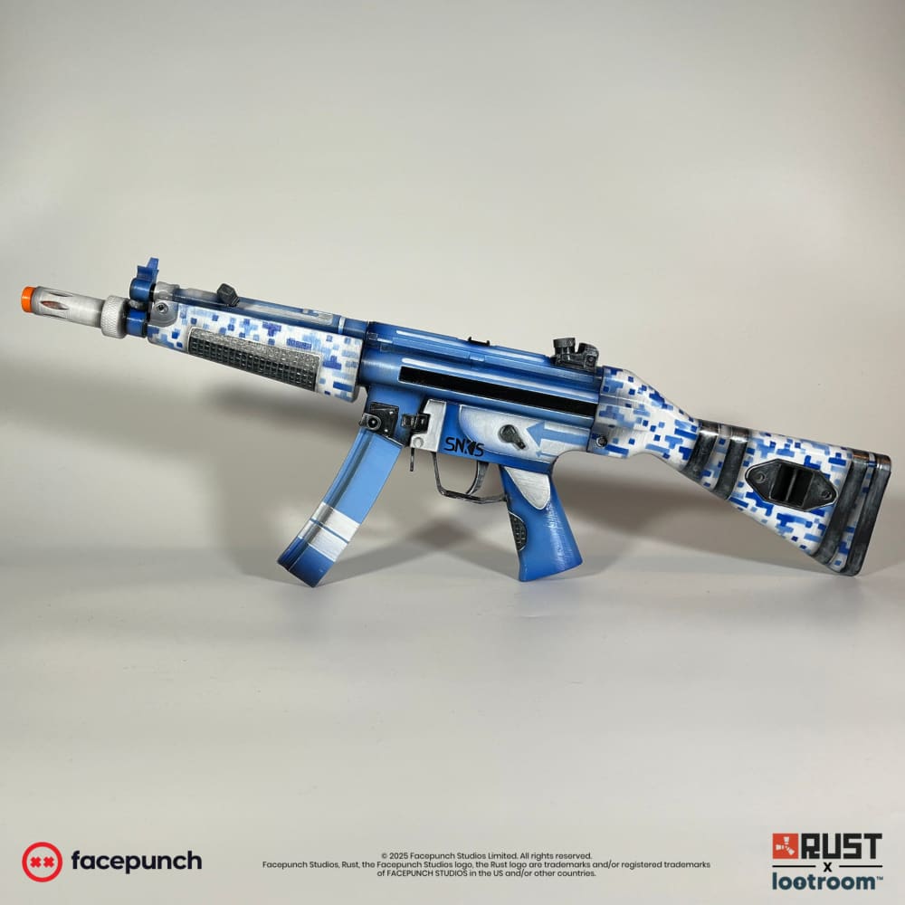 Rust Sinks MP5 prop from the side, blue digital camo on handguard and stock with the silver barrel.