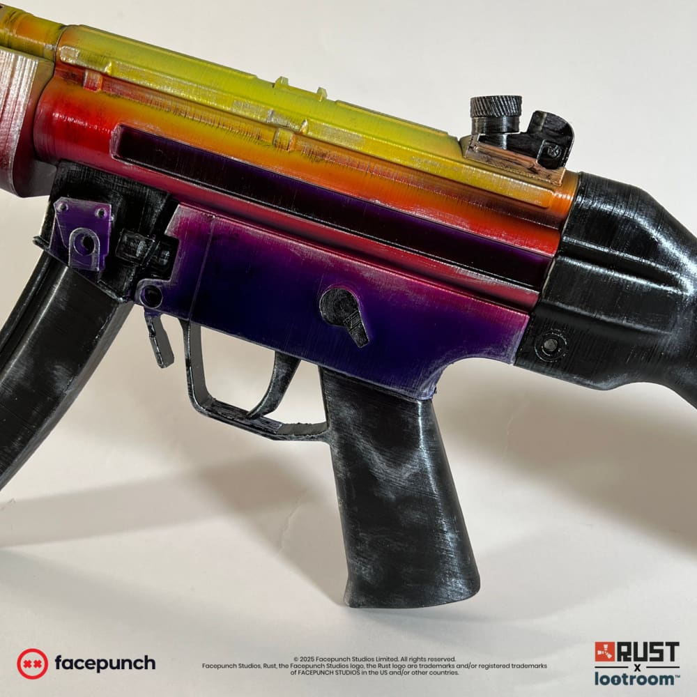 Close-up of the Rust Tempered MP5 prop's receiver, violet below the yellow and orange of the barrel.