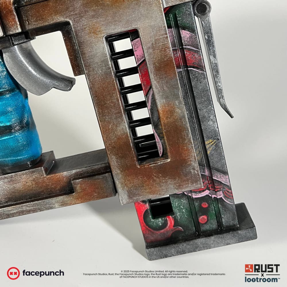 Close-up of the Rust Nailgun's magazine, a plate painted in red, pink and green.