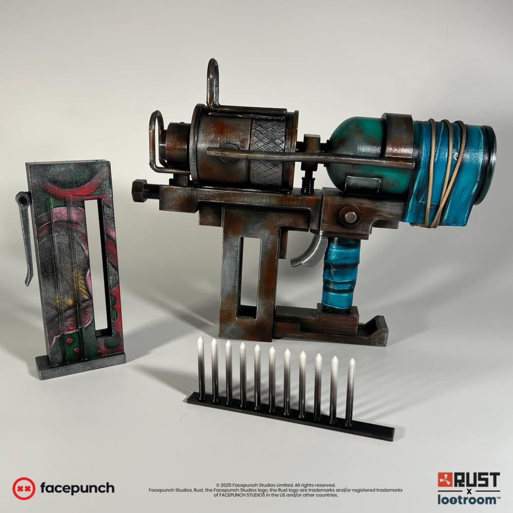 The Rust Nailgun prop with its magazine taken out and the ten nails that come with it.