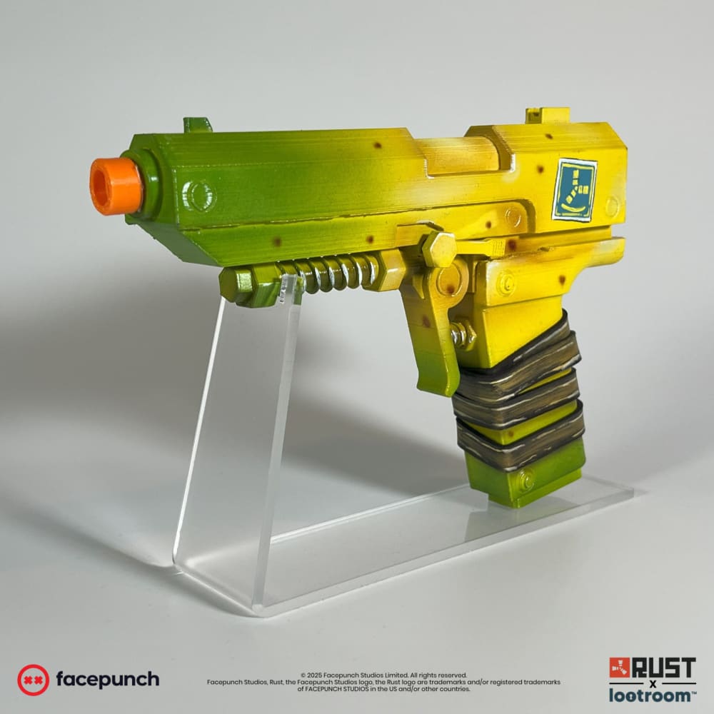 Rust SAPnana P2 prop at an angle, green muzzle end and yellow frame with the taped grip