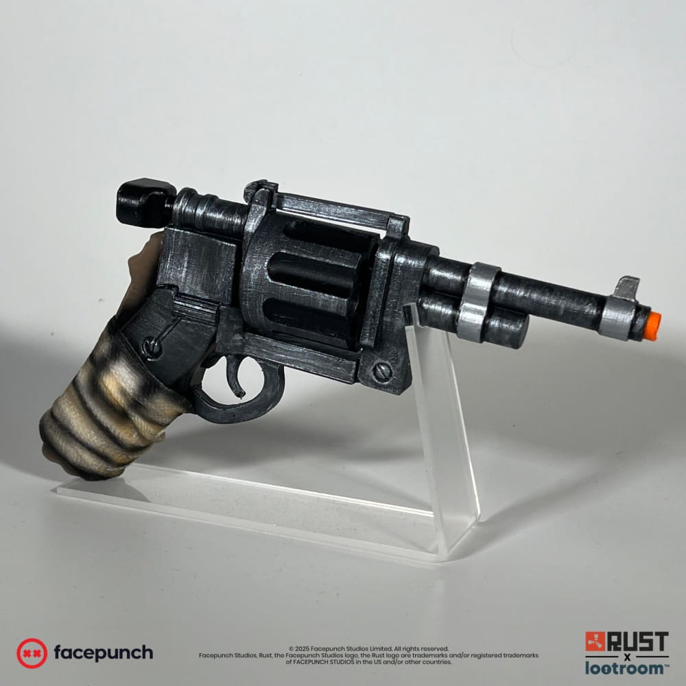 Rust Revolver prop, side view, dark gunmetal with a pale wrapped grip and open cylinder