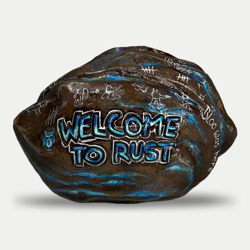 Rust Blooprint Rock prop, front view with raised WELCOME TO RUST lettering and the blue Blooprint wolf logo
