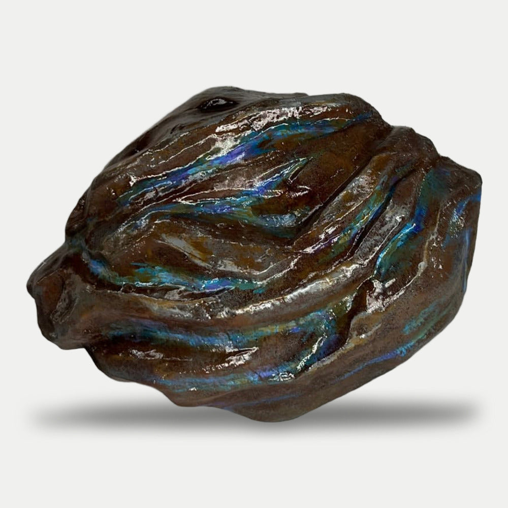 Back of the Blooprint Rock, dark brown with iridescent blue streaks and no lettering