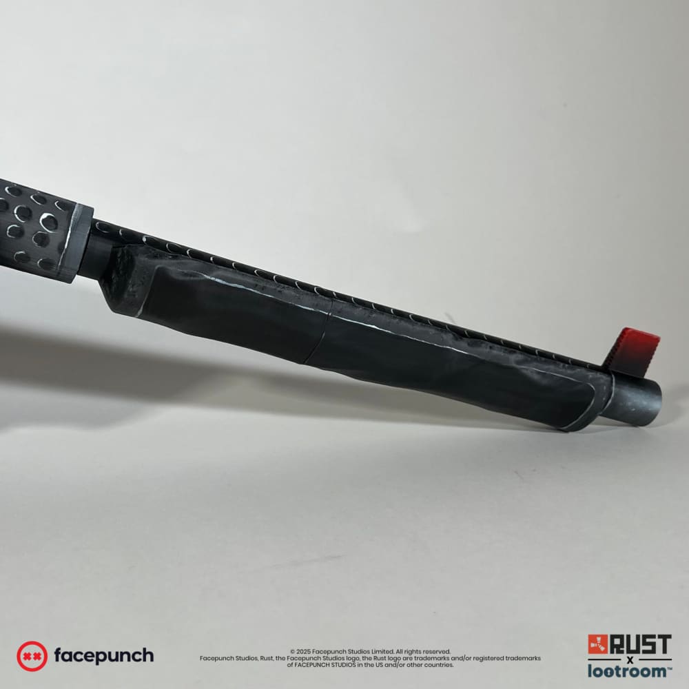 The barrel of the Rust bchillz SAR prop, wrapped in a real black band beside the perforated handguard.