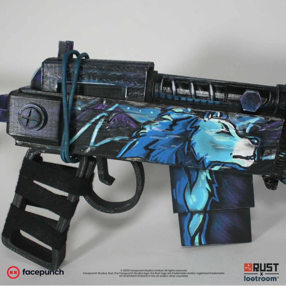 Close-up of the Rust Blooprint SAR prop's receiver, the howling wolf and the real cyan cord on the handguard.
