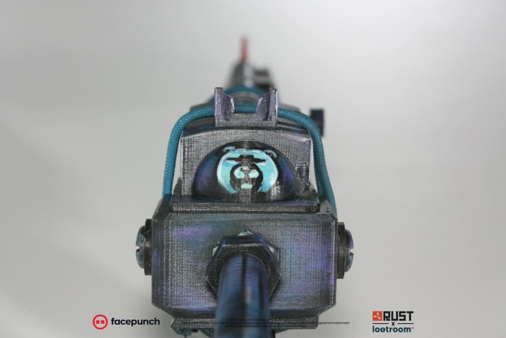 Head-on view of the Rust Blooprint SAR prop, showing the round emblem glowing cyan in the top of the receiver.