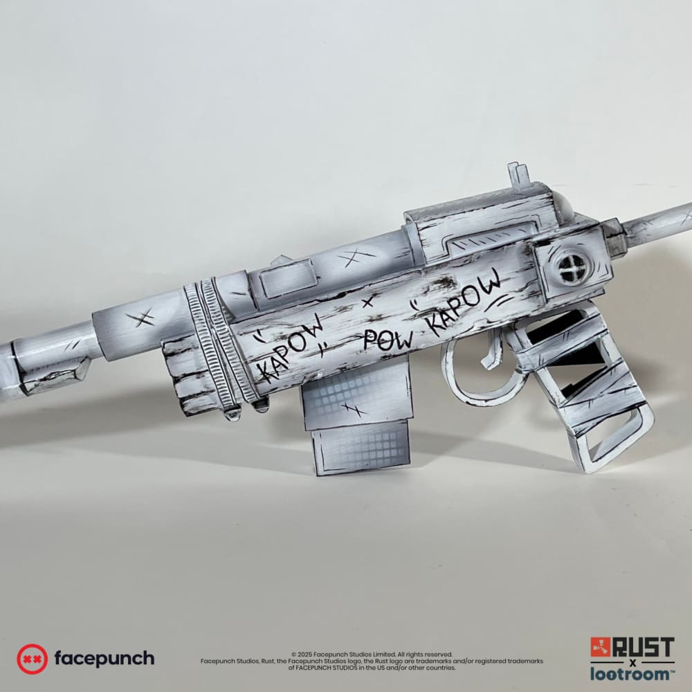 The Rust Comics SAR prop at an angle, with KAPOW POW KAPOW hand-lettered across the receiver.
