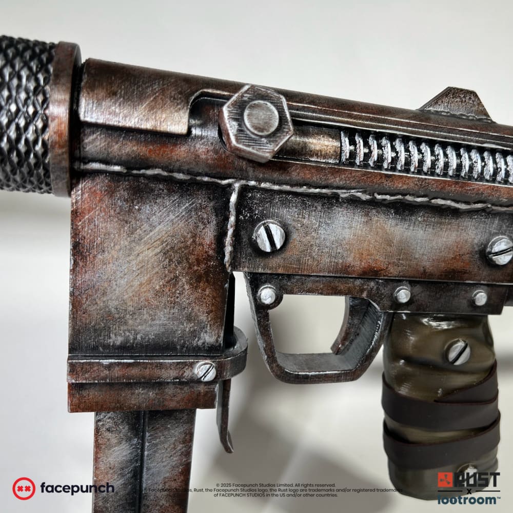 Close-up of the Rust SMG prop's receiver with the slotted screws, the trigger and the painted weld seam.