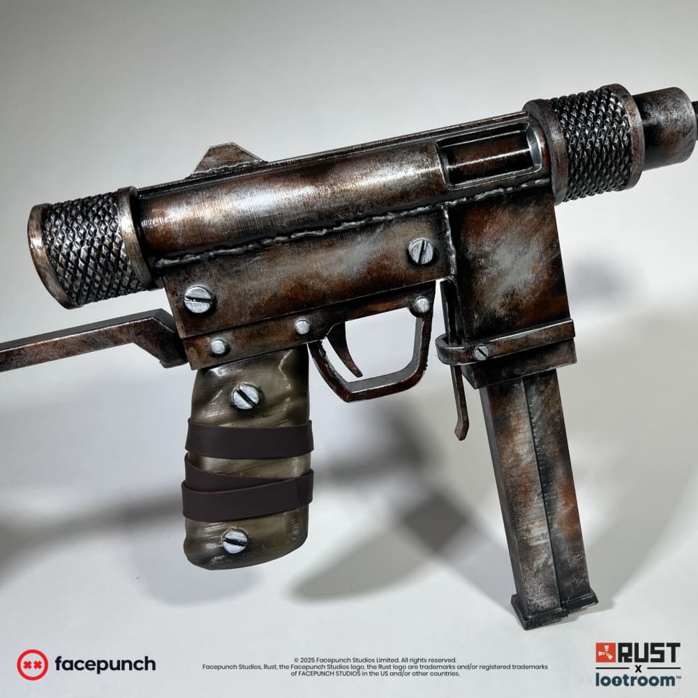 The Rust SMG prop's olive grip wrapped in brown bands, with the magazine and the rod-look stock behind it.