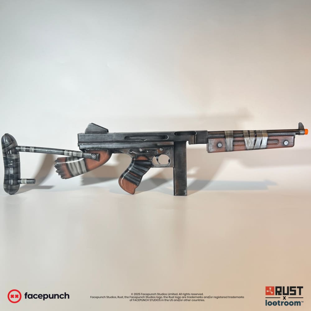 Rust Thompson prop from the right, dark gunmetal body with reddish wood-look grip and the rod-look stock