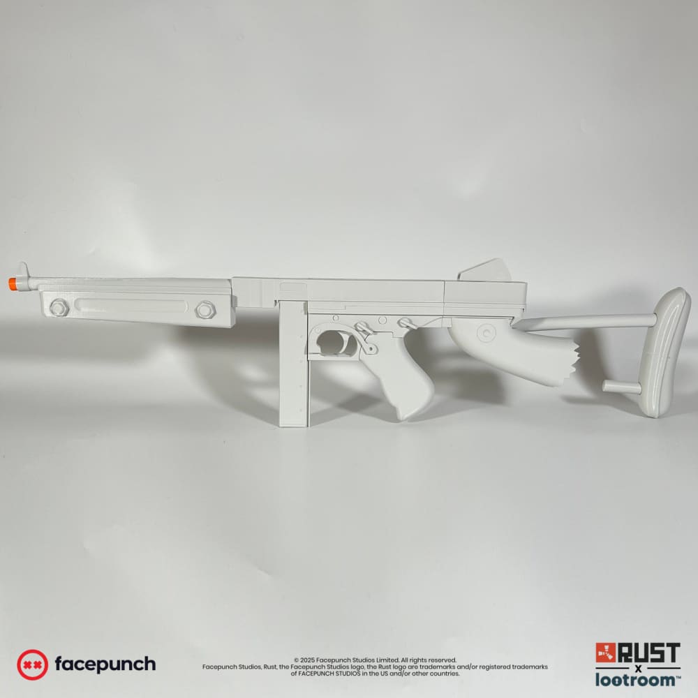 Unpainted light grey Rust Thompson prop from the left, with the straight box magazine and the oval loop at the end of the stock